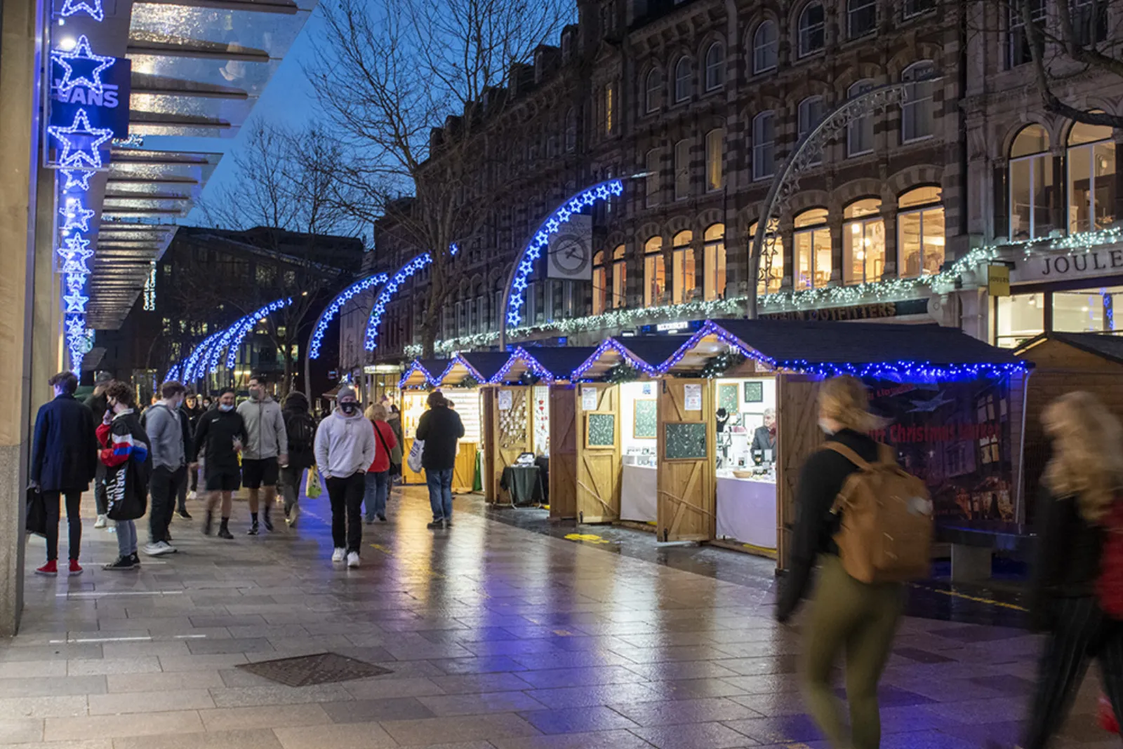 Christmas market huts and blue lights along The Hayes in Cardiff